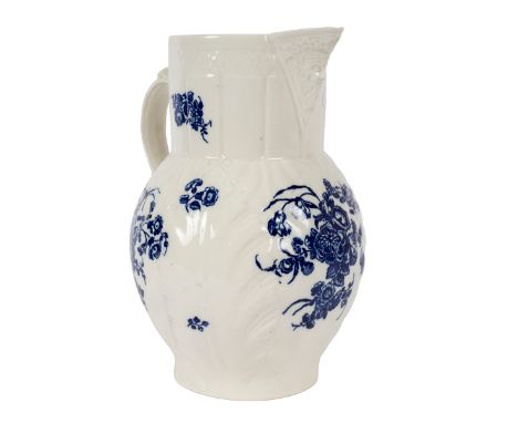 A Caughley cabbage-leaf moulded mask jug, circa 1780, printed in blue with flower sprays, 25cm high/Provenance: Spetchley Par