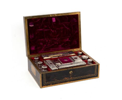 A George IV coromandel and brass mounted dressing case by D Edwards, 21 King St, Bloomsbury, London, containing an almost com