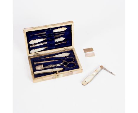 A mother of pearl and silver necéssaire, Chester 1901, complete with implements, 12.5cm wide and a small mother-of-pearl fold