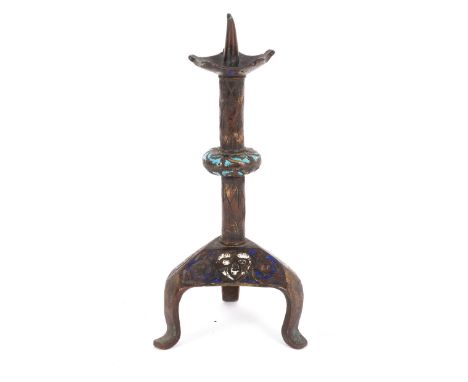 A Limoges style champlevé enamelled gilt copper candlestick, with knopped column to a triform base, 22cm high/Provenance: Spe