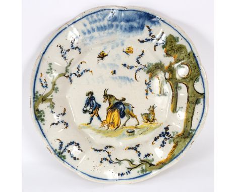 A Savona (Folko Factory) lobed circular dish, late 18th Century, painted in high temperature colours with a couple milking go