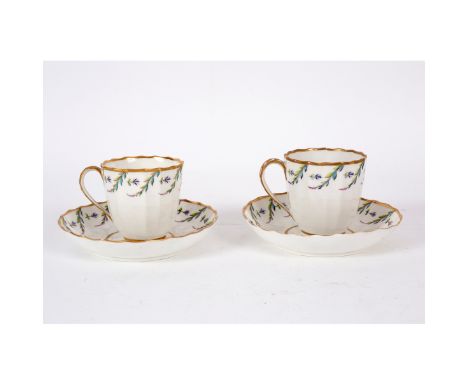 A pair of Pinxton fluted coffee cups and saucers, enamelled with simple pendant foliage, iron red enamel P.63 marks/Provenanc