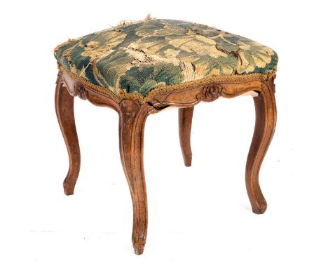 A French provincial walnut stool, circa 1750, the tapestry seat on moulded cabriole legs (distressed), 50cm wide/Provenance: 