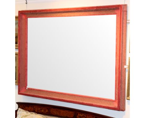 A large wall mirror, the rectangular plate in a concave frame with pink fabric covering, total size 122.5cm x 163.5cm/Provena