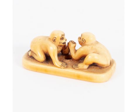 A Japanese ivory netsuke, 18th Century, in the form of two monkeys arm wrestling, 4.5cm long/Provenance: Spetchley Park/see i