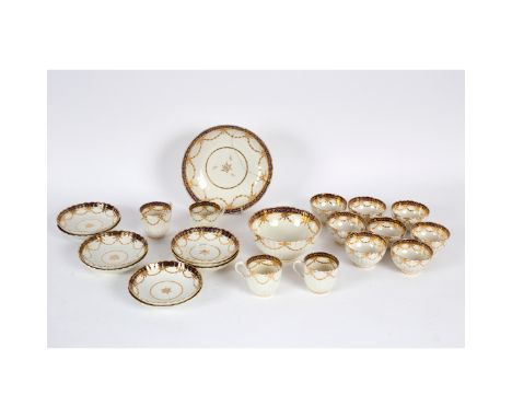 A Caughley part tea service, late 18th Century, each fluted piece with curtained gilt trails beneath a gros bleu and gilt bor