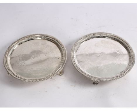 A pair of George III silver salvers, Hannam & Crouch, London 1805, circular with gadrooned borders and on three paw feet, cre