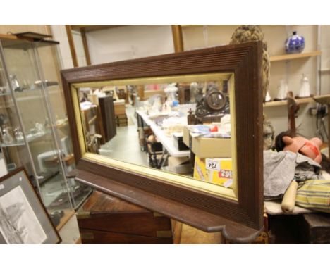A vintage oak overmantle with ribbed design and looking glass