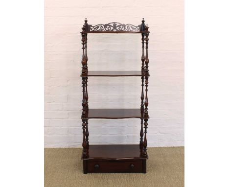A Victorian Mahogany Whatnot A Victorian Mahogany Whatnot, of serpentine outline with pierced gallery and turned finials abov
