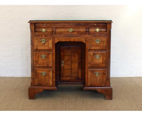 A Good George II Walnut Kneehole Desk A Good George II Walnut Kneehole Desk, the shaped and moulded rectangular top with herr