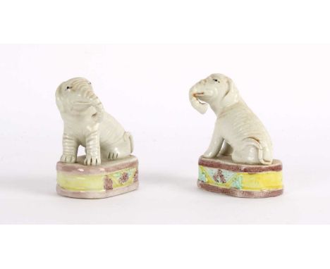 A Near Pair of Chinese Porcelain Miniature Model Elephants Qing Dynasty Circa 18th/19th century, both modelled seated in pale