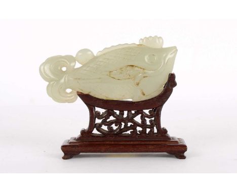 A Chinese Carved Celadon Jade Fish Ming Dynasty A Chinese Ming Dynasty Carved Celadon Jade Fish, with russet inclusions, mode