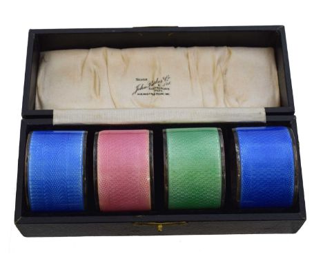A cased set of George V silver enamel napkin rings. Turner &amp; Simpson, Birmingham, 1933, gross weight 3.16ozt.Overal condi
