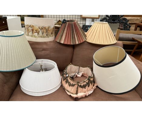 A gilt metal hanging light shade together with a collection of lamp and light shades 