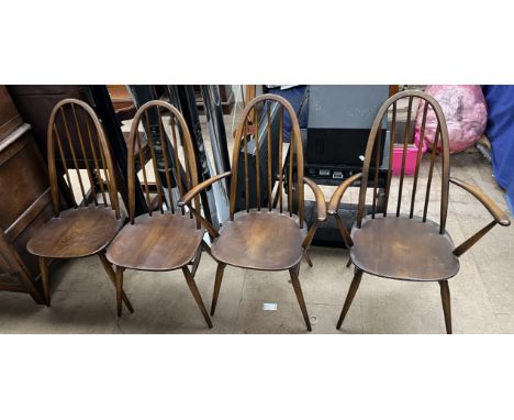 A set of four Ercol stick back dining chairs on tapering legs, includes two arm chairs 