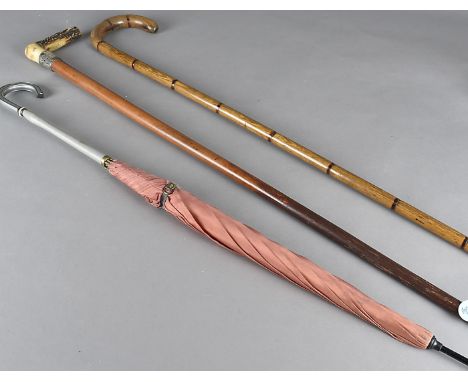 Three walking sticks and canes, two silver mounted, a bamboo shooting stick dated Xmas 1896, and three parasols (7) 