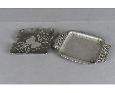 Two Tudric pewter art nouveau pin trays, including a twin handled hammer beaten example with Celtic knot design, impressed to