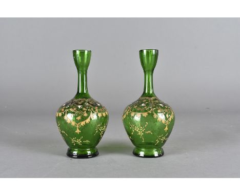 A pair of 19th Century continental green glass bottle vases, with appiled enamel floral design, heightened in gilt 15 cm high