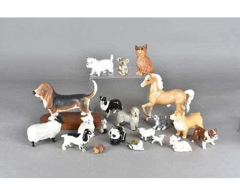 A collection of Beswick and other porcelain animals, including a Palamino pony, a Sylvac corgi, other Beswick dogs, a sheep, 