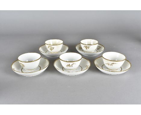 A part late 18th or early 19th century soft paste porcelain English tea set, heightened in gilt, including nine tea bowls and