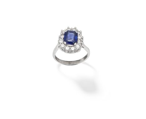 SAPPHIRE AND DIAMOND-SET CLUSTER RINGThe rectangular step-cut sapphire within a brilliant-cut diamond surround, ring size app