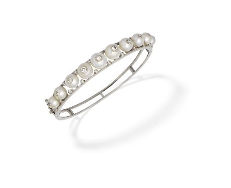 CULTURED PEARL AND DIAMOND BANGLE,  LATE 20th CENTURYThe 6.6mm-8.8mm cultured pearls inset with brilliant-cut diamonds, with 