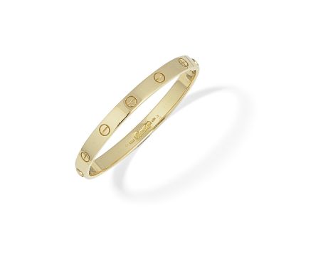 CARTIER: 'LOVE' BANGLEWith screwhead motifs, mounted in 18 carat gold, signed Cartier, numbered, European convention mark, Sw