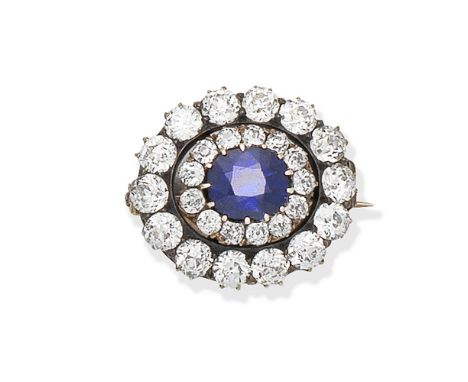 SAPPHIRE AND DIAMOND CLUSTER BROOCH, CIRCA 1890The oval-cut sapphire and old brilliant-cut diamond cluster, within an openwor