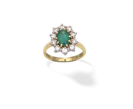 EMERALD AND DIAMOND CLUSTER RINGThe oval-cut emerald within a brilliant-cut diamond surround, mounted in 18 carat gold, Londo