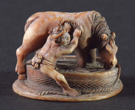 JAPANESE IVORY NETSUKE, carved as a boy washing a horse in a large bath, signed, 3.2cm