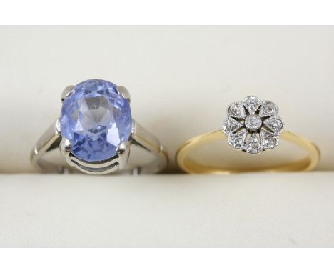 A DIAMOND CLUSTER RING set with circular-cut diamonds, in 18ct. gold. Size N, together with a sapphire single stone ring, siz