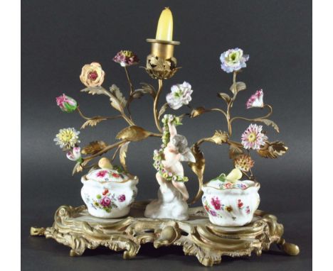 FRENCH GILT METAL AND PORCELAIN MOUNTED INKSTAND late 19th Century, a central cherub and a pair of covered inkwells before a 