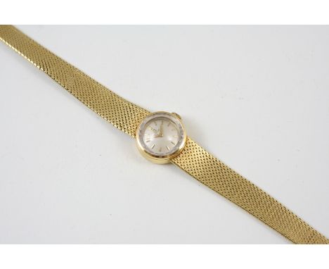 A LADY'S 18CT. GOLD WRISTWATCH BY OMEGA the signed circular dial with baton numerals, on an integrated bracelet with ladder c
