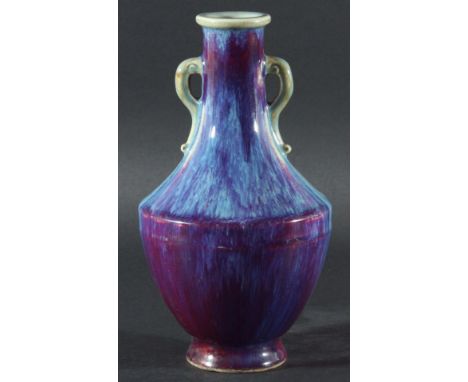 CHINESE FLAMBE VASE, of two handled baluster form, with a mauve to blue mottled glaze, Kangxi style mark, 22cm