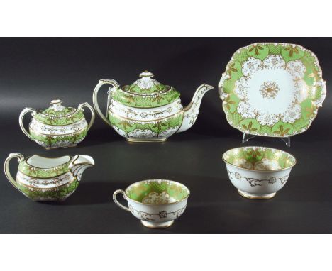 ROCKINGHAM STYLE TEA SERVICE, possibly Paragon Rockingham, with gilt scrolling decoration on an apple green and white ground,