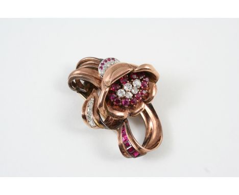 A RUBY AND DIAMOND FLORAL BROOCH the central flower head set with circular-cut rubies and diamonlds, with further diamonds se