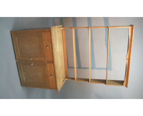 HEAL & SON DRESSER made in oak, the base with two drawers and two cupboard doors. With a boarded interior and a shaped shelf,