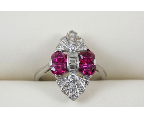 AN ART DECO RUBY AND DIAMOND MARQUISE-SHAPED CLUSTER RING centred with three baguette-cut diamonds and four rubies within a s