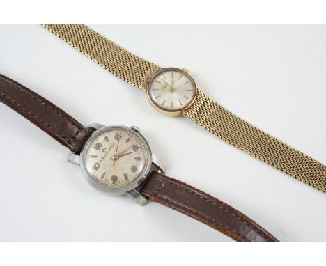 A LADY'S 9CT. GOLD WRISTWATCH BY LONGINES the signed circular dial with baton numerals, on a gold integrated bracelet with la
