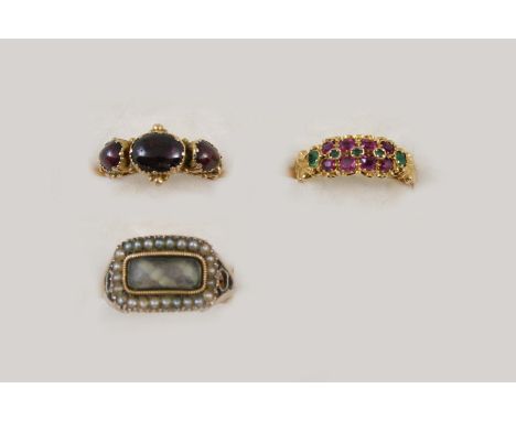 A GEORGIAN GARNET RING set with three cabochon garnets in gold, size L, a Georgian gold ring set with half pearls, centre sec