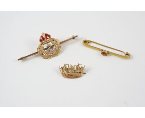 AN ENAMEL AND GOLD NAVAL BROOCH 5cm. long, together with a 9ct. gold naval crown brooch, 2cm. wide and a 9ct. gold bar brooch