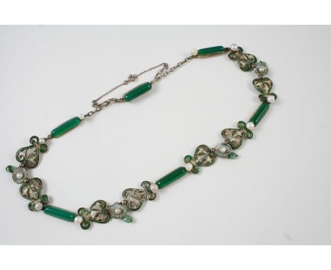 AN ENAMEL FLORAL AND SHELL NECKLACE the green enamel decoration set with small pearls, and with green glass spacers, set in g