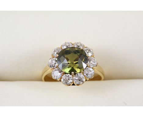 AN ALEXANDRITE AND DIAMOND CLUSTER RING the rectangular cushion-shaped alexandrite weighs 3.77 carats and is set within a sur
