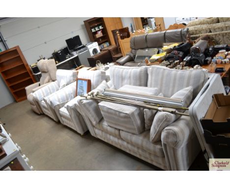 A stripe upholstered three piece suite comprising of a two seater settee, two matching armchairs, and a pouffe