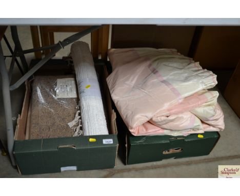 Two boxes containing curtains, materials, a bathroom mat etc.
