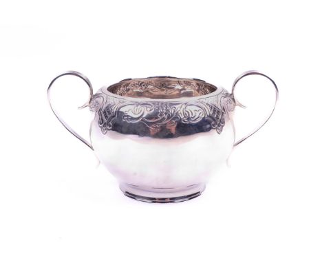 A silver twin handled sugar bowl. Decorated around the rim with scrolls and lappets, hallmarks for Sheffield, 1927, Thomas Br