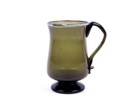 A 18th century Nailsea green glass tankard. With blue glass decoration to the rim, applied handle. H15cm Condition Report: Ov