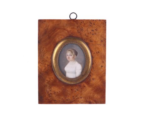 An early 19th century portrait miniature on ivory. The young lady with hair tied up in a bun, wearing a white dress with fril