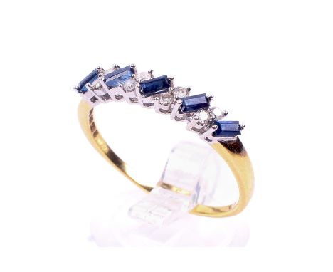 An 18ct gold dress ring. Set with five baguette cut sapphires of 0.20 carats estimated total weight and eight round brilliant