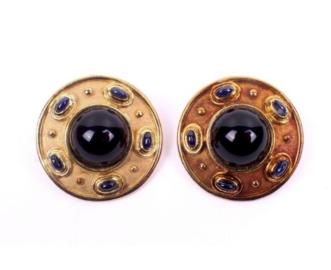 A pair of 18ct gold and sapphire clip earrings. Set with oval cabochon cut sapphires with a large centre round cabochon assum